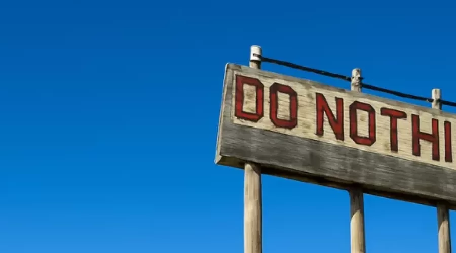 wooden sign saying DO NOTHING